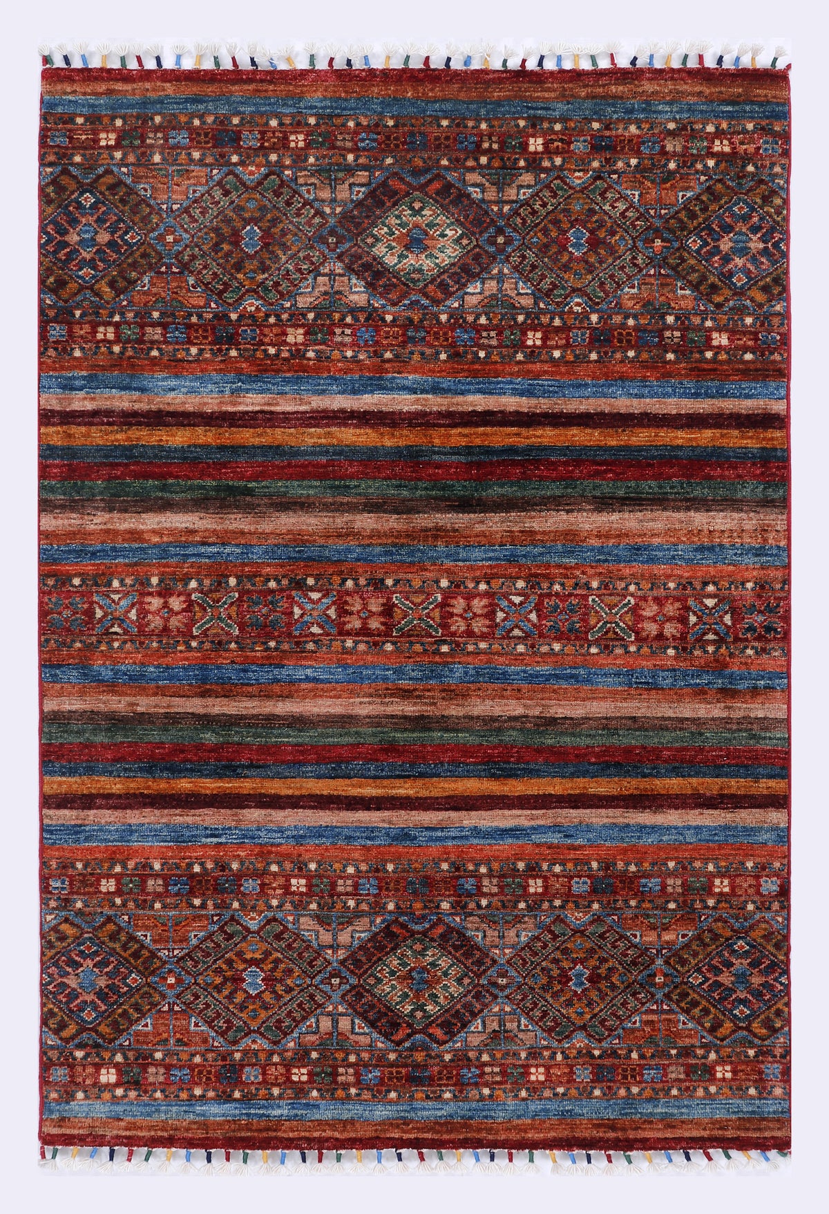 Red and navy patterned rug with geometric motifs and fringe edges, rectangular