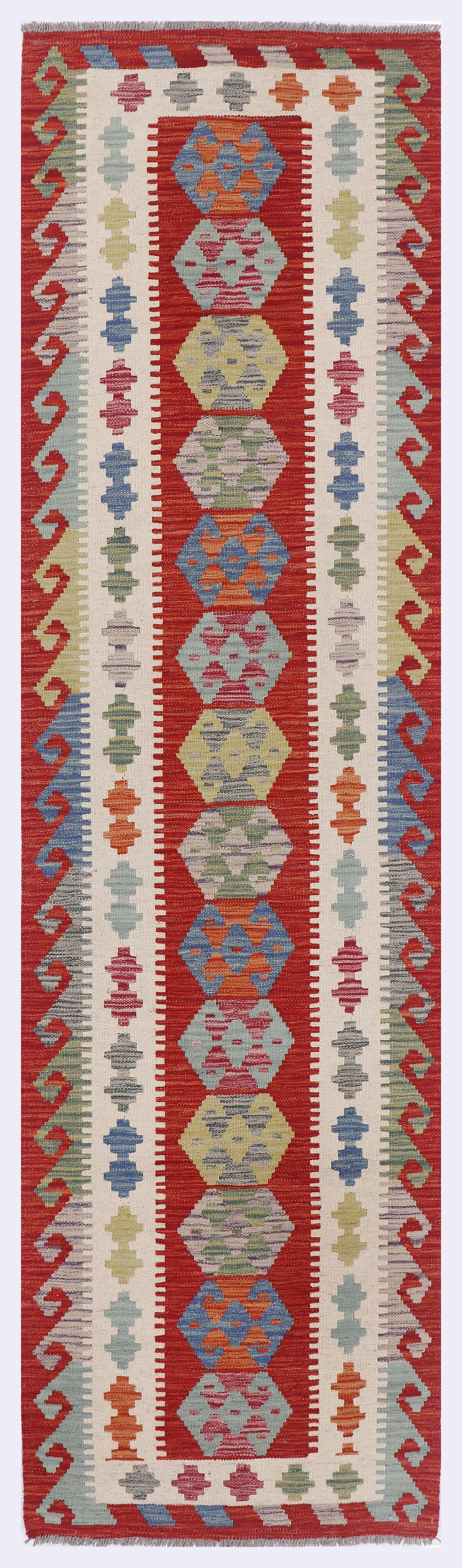 Caravan Spirit Kilim rug with vertical geometric panels in red, blue, and cream.