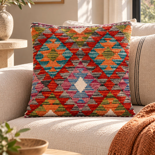 Multicolor diamond-pattern kilim cushion on beige sofa, 45x45 cm