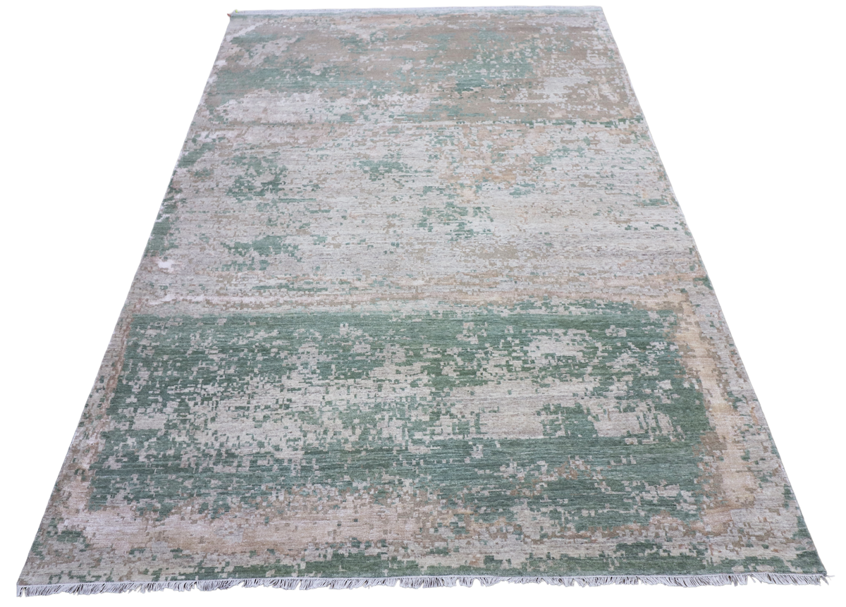 Rectangular modern area rug with distressed pattern in jade green, beige, and gray