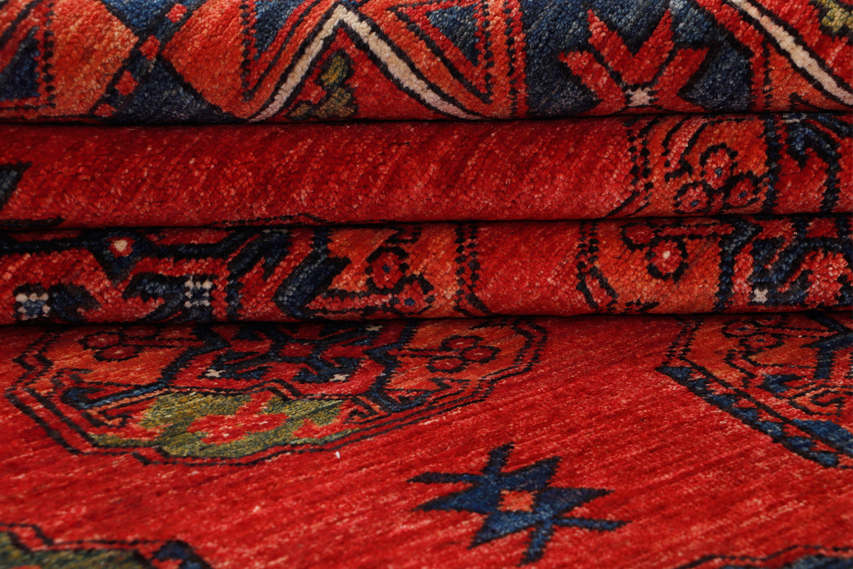 Red Afghan Ersari rug with geometric border and star motifs