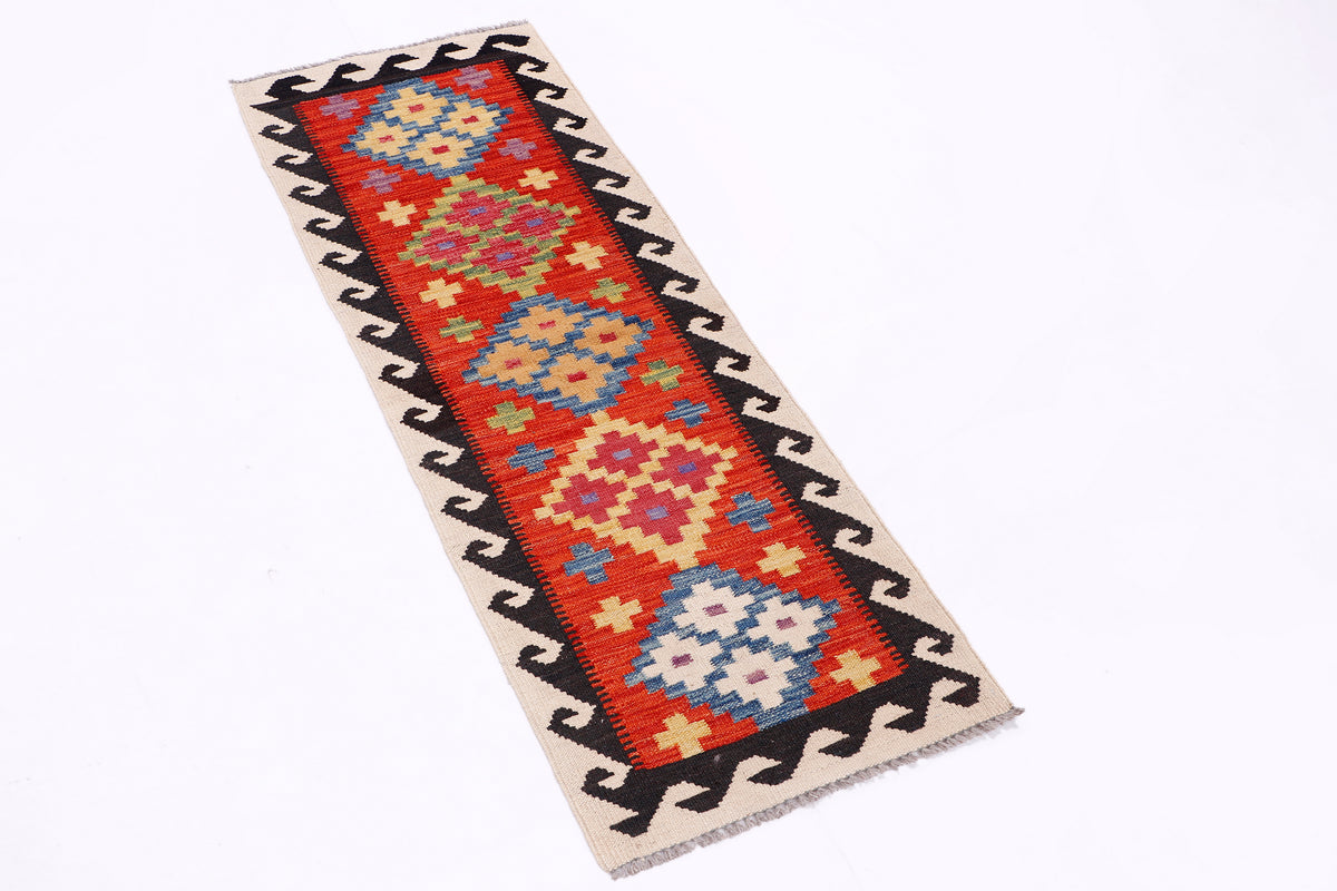 Kilim runner rug with red, blue, and cream geometric blocks and black zigzag edges