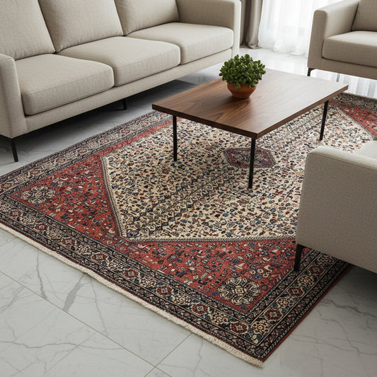 Rectangular Persian-style area rug with red, cream, and navy floral medallion border