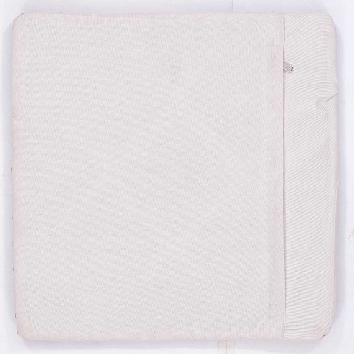 Off-white kilim pillow cover back with stitched border, no visible pattern