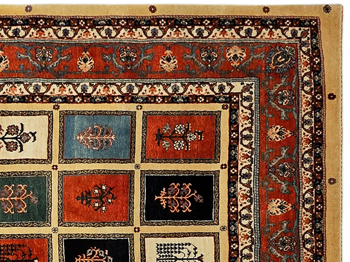 Close-up of rug design with red field, cream squares, and detailed black border pattern