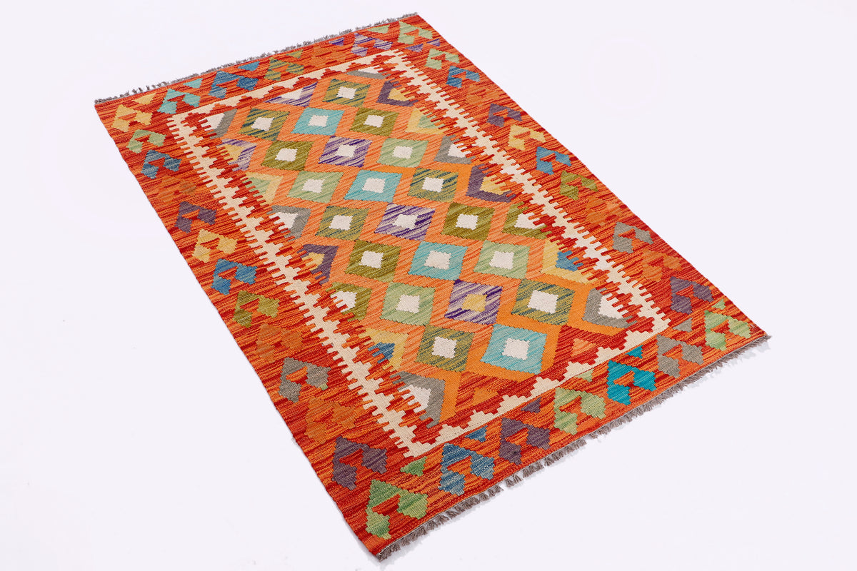 Orange kilim rug with zigzag and diamond pattern in blue, green, and multicolor accents