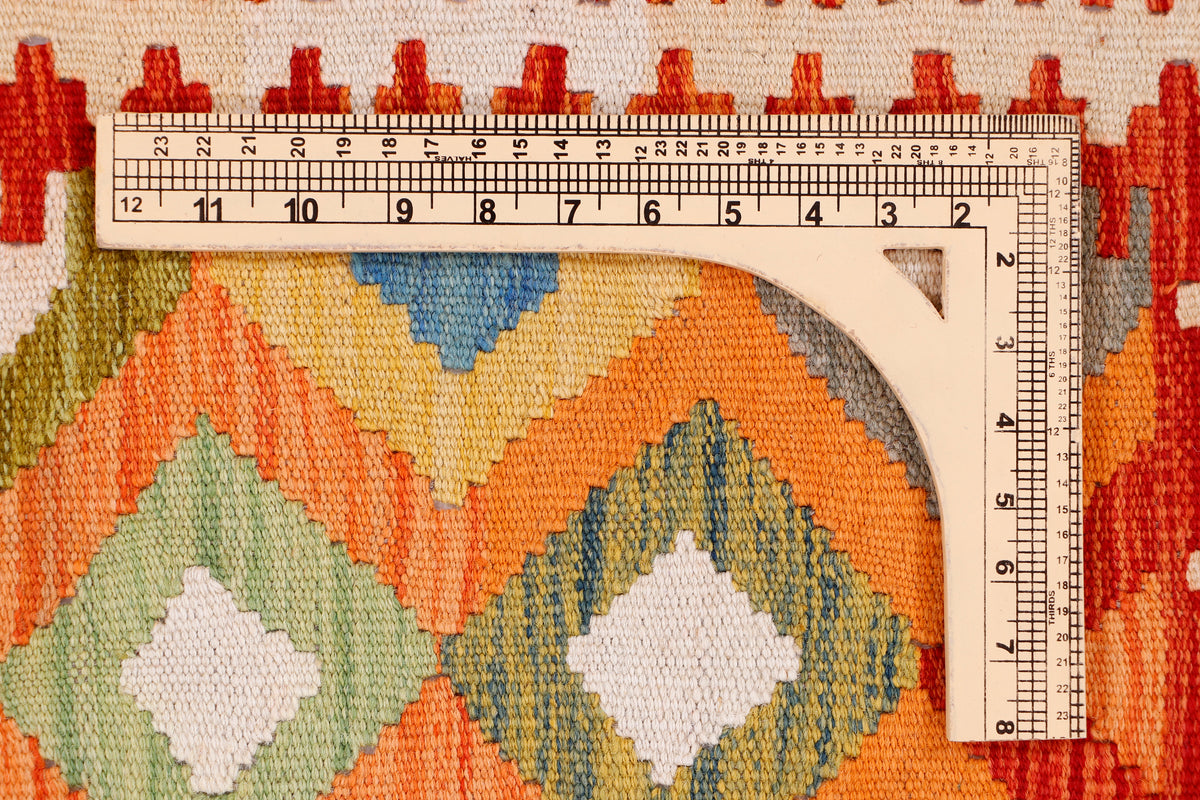 Kilim rug pattern with ruler for size, orange border and multicolor diamond repeats
