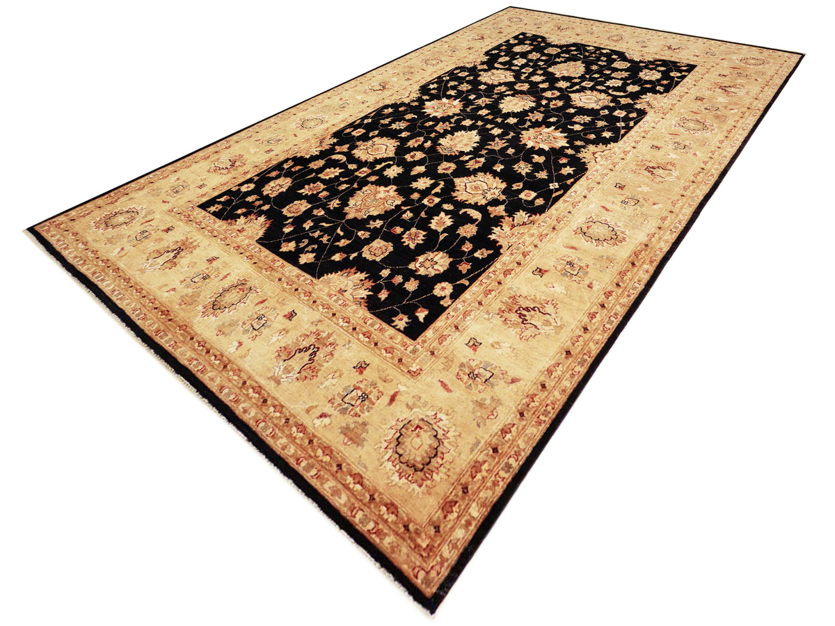 Afghan rug viewed diagonally: beige ground with black center field and floral border details.