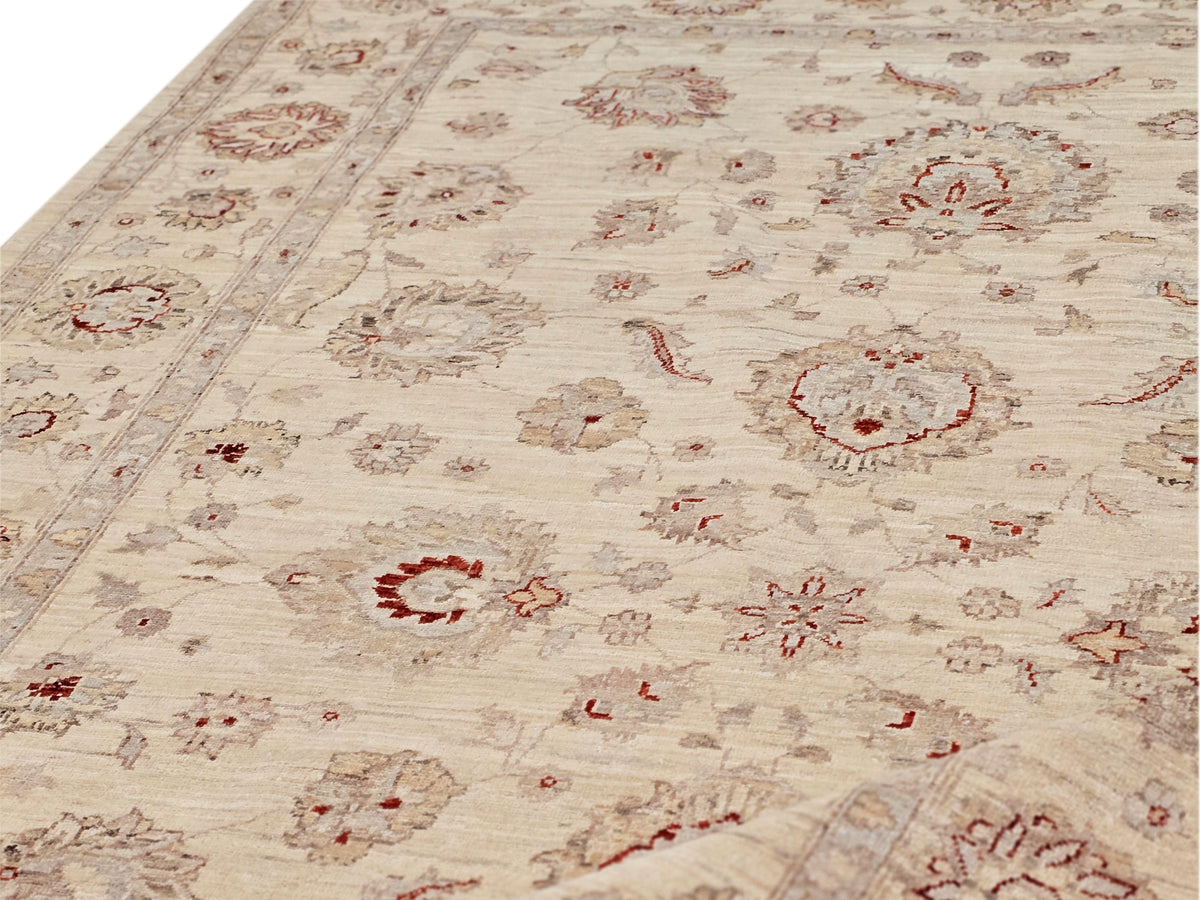 Afghan rug close-up: cream background with red medallions and distressed lines