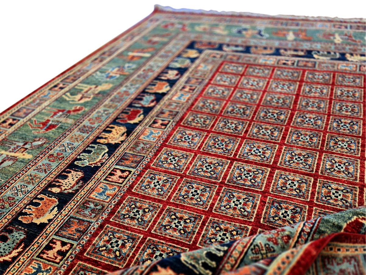 Multicolor rug with red geometric panels and dark blue ornamental border.