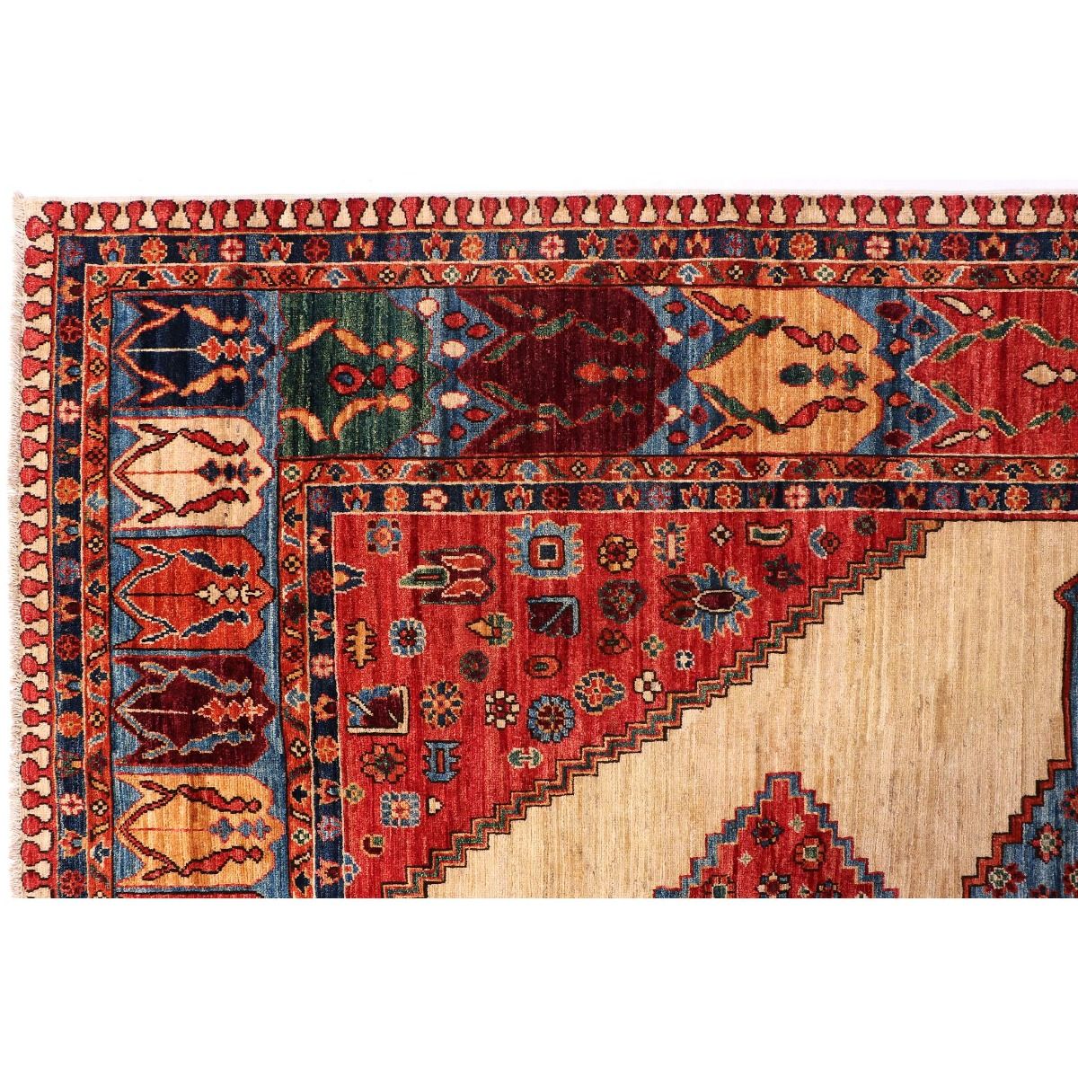 Rug corner detail with red field, cream motif panels, and blue and green border accents.