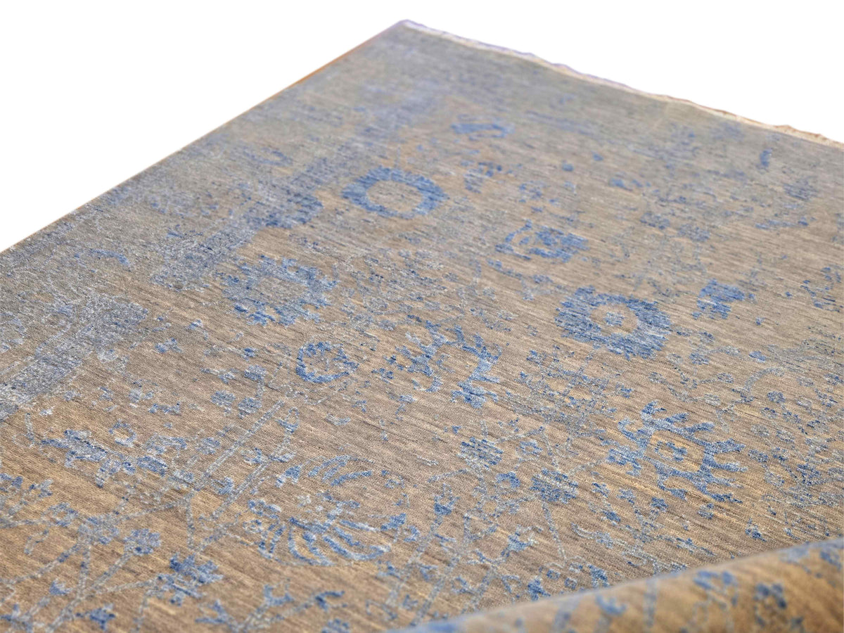 Close-up of blue and beige abstract rug texture with short fringe
