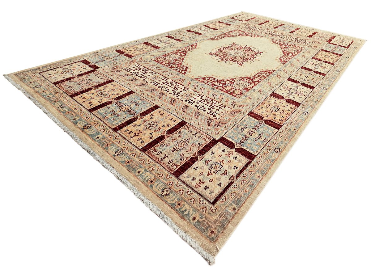 Ariana area rug with cream and red center medallion, dark corner squares, and textured fringe.