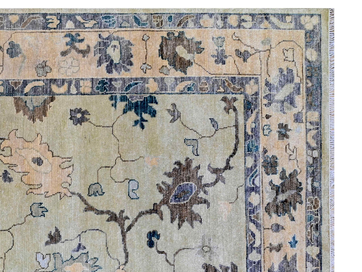 Oushak rug close-up with cream background, dark blue motifs, and ornate border details