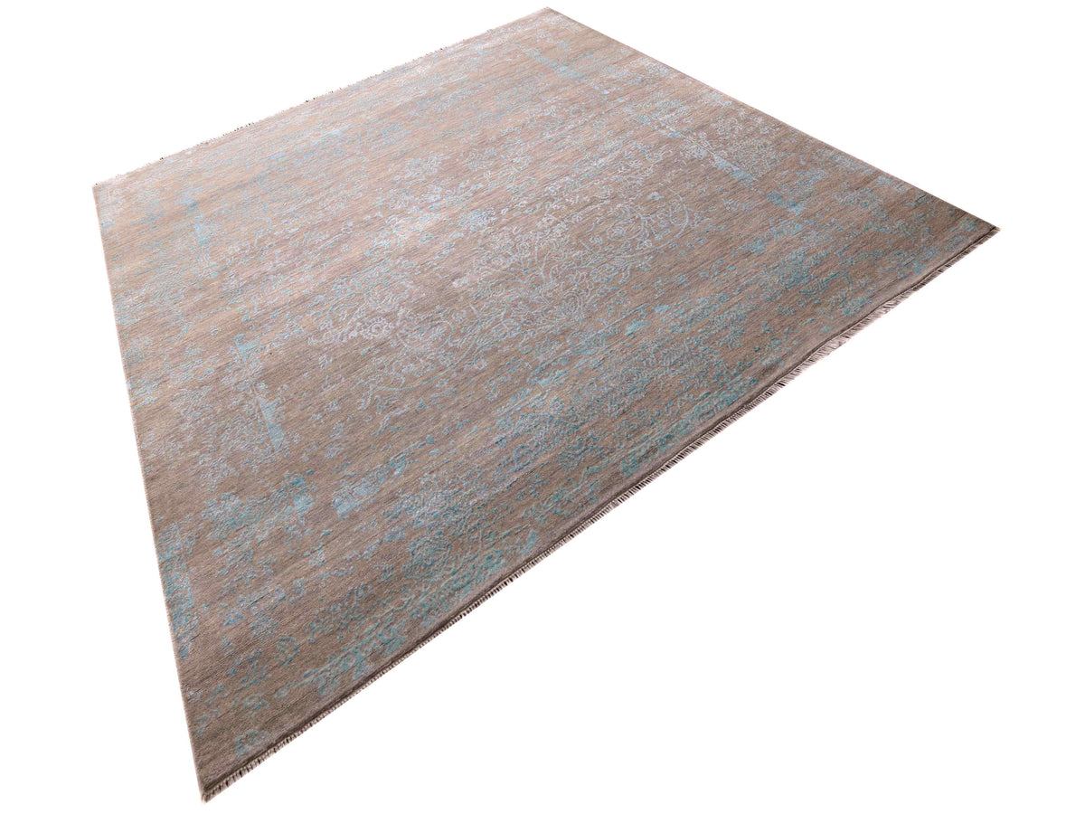 Modern rectangular area rug with distressed tan and muted blue design, flat woven look