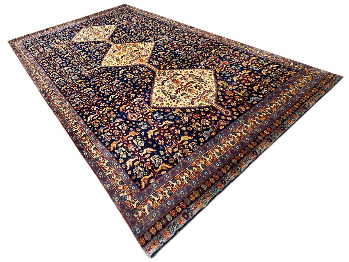 Dark navy Loribaft-style rug with diamond medallion and detailed border pattern