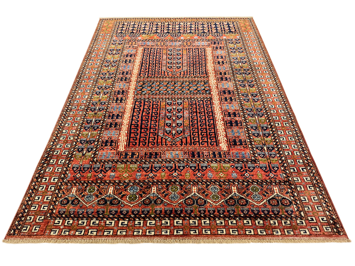 Geometric rug with red center panels, navy details, and repeating beige corner ornaments