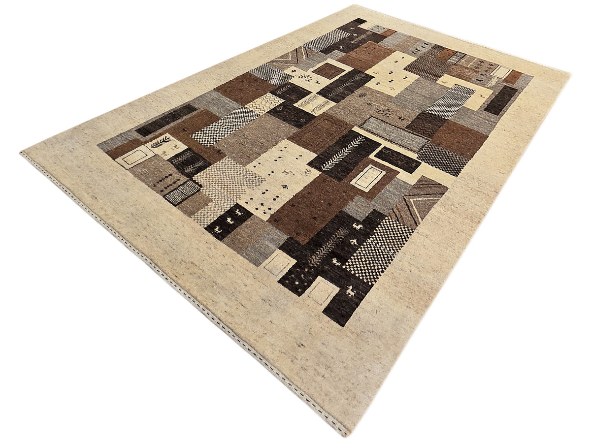 Square view of geometric patchwork rug in beige, brown, black, and cream
