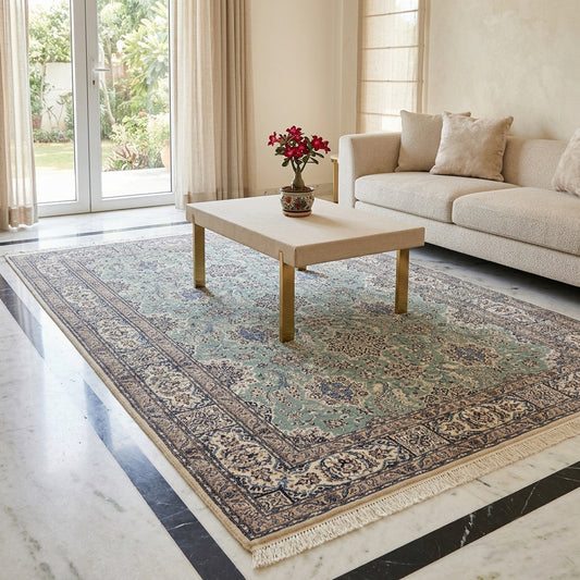 Nain rug styled in a living room with teal floral design and cream fringed border