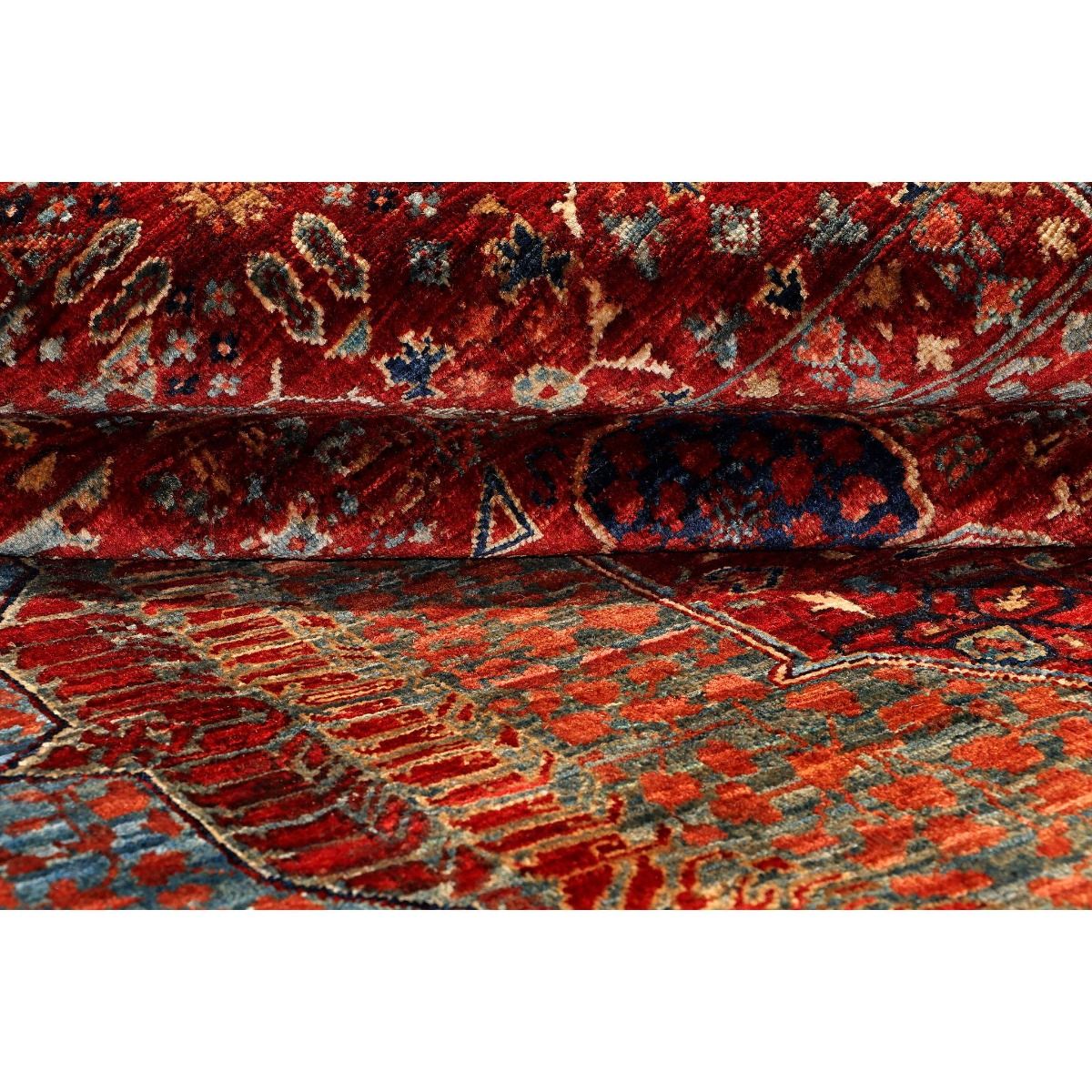 Woven area rug texture with red, teal, and blue pattern lines and ornamental shapes