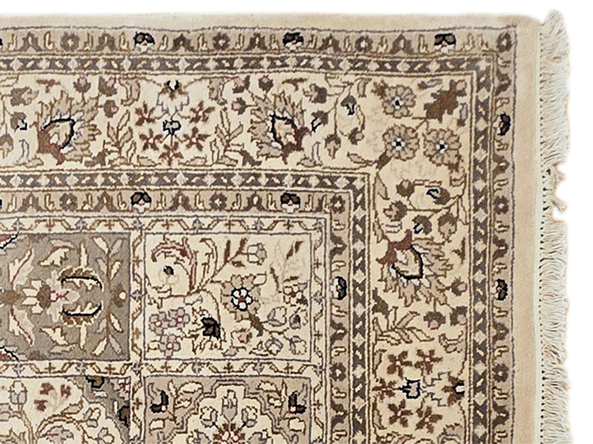 Bakhtiar rug border detail with floral and geometric motifs and fringe on the right edge.