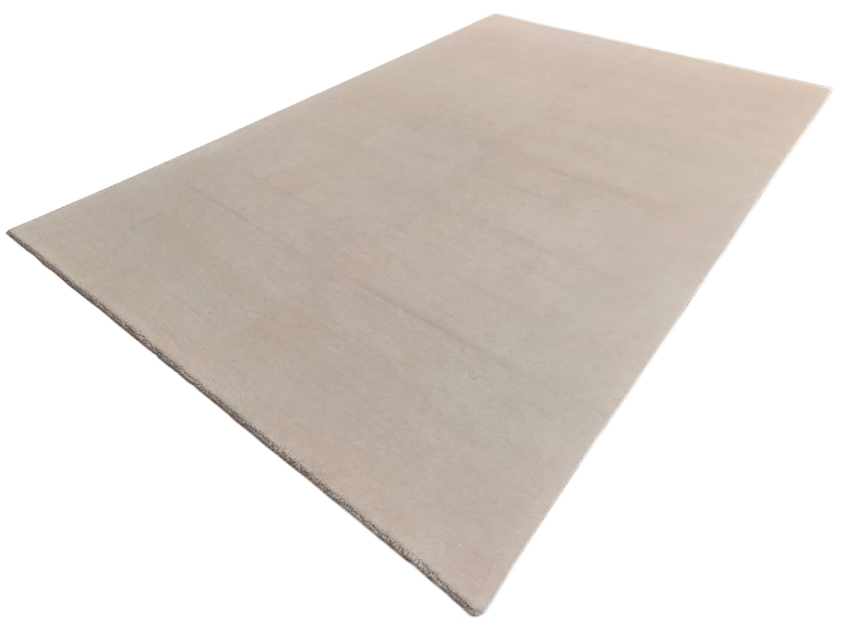 Light beige flatweave rug photographed at a diagonal angle with smooth face.