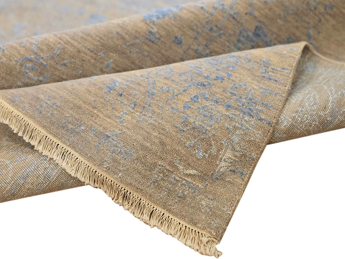 Blue and beige modern rug corner showing short fringe and woven texture