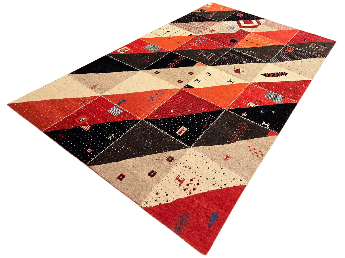 Patchwork Persian rug with diamond and striped shapes in red, black, and cream