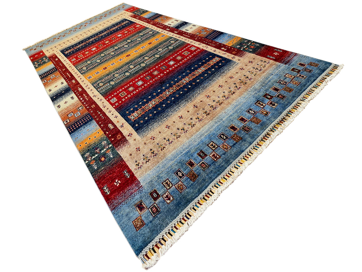 Rectangular area rug with multicolor stripes, central medallion, and short fringe.