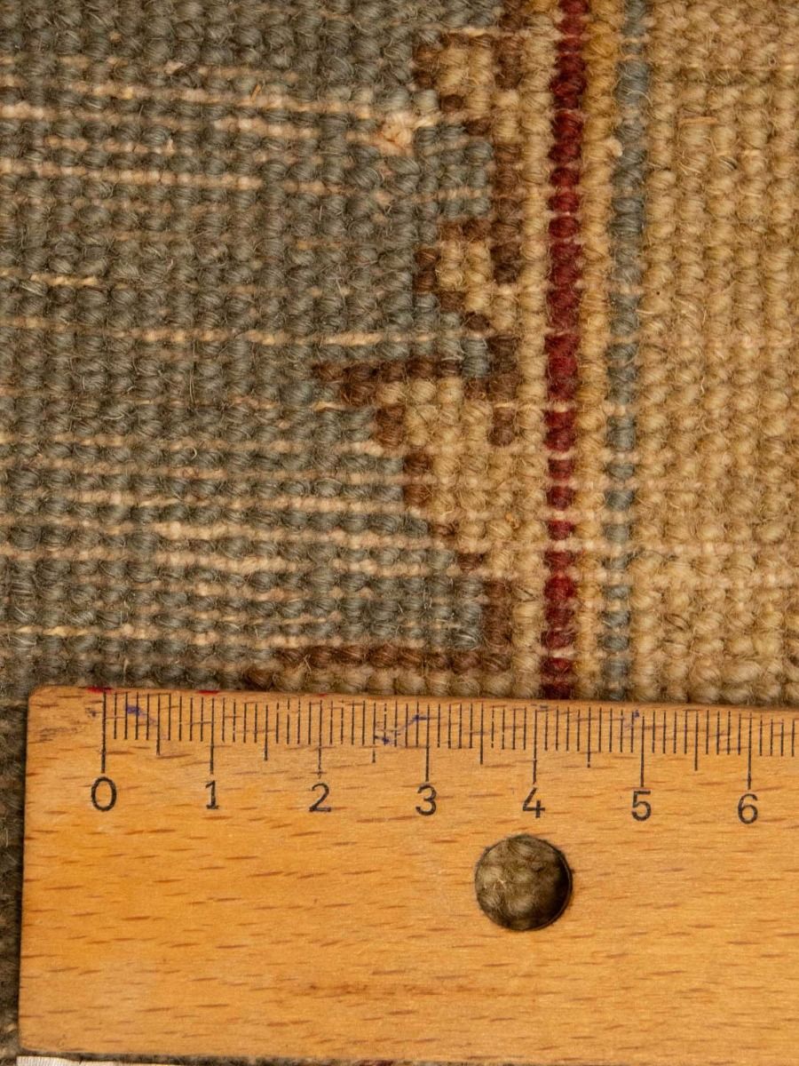 Patchwork rug close-up with woven texture, geometric pattern, and ruler for scale
