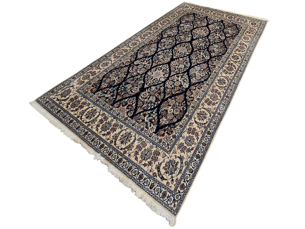 Navy and cream floral Persian-style rug with ornate border and short fringe edges