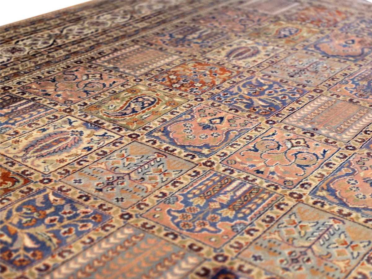 Close-up of multicolor Qum-style rug field with blue and rust floral patterns