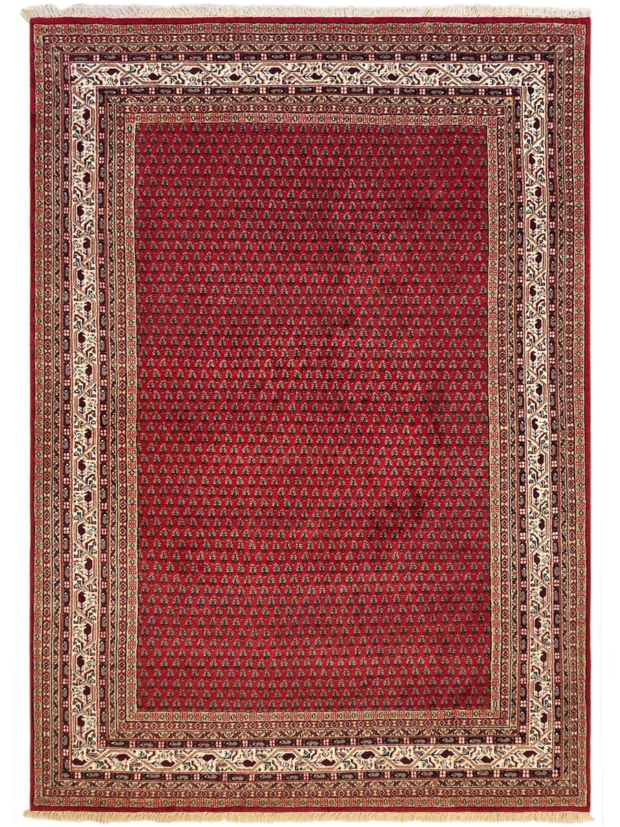 Red Indo Mir area rug with ornate geometric border and patterned center, rectangular
