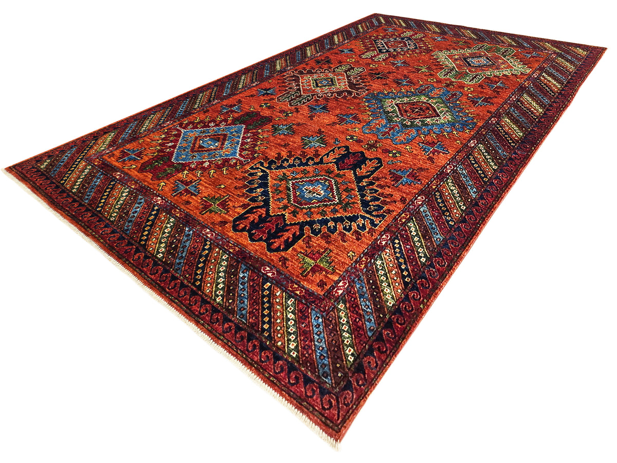 Rectangular 245x172 cm rug in red-orange with centered medallions and detailed border