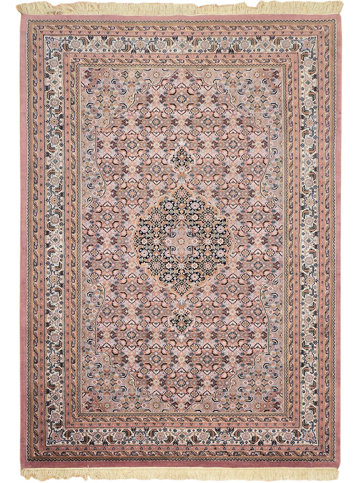 Bidjar rug front view with dusty rose frame, blue medallion center, and cream fringe