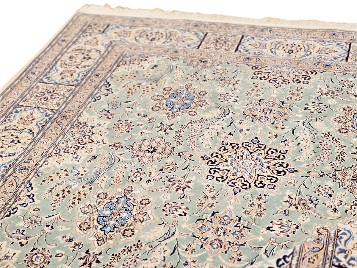 Nain rug close-up with teal field, pale motifs, and intricate floral pattern