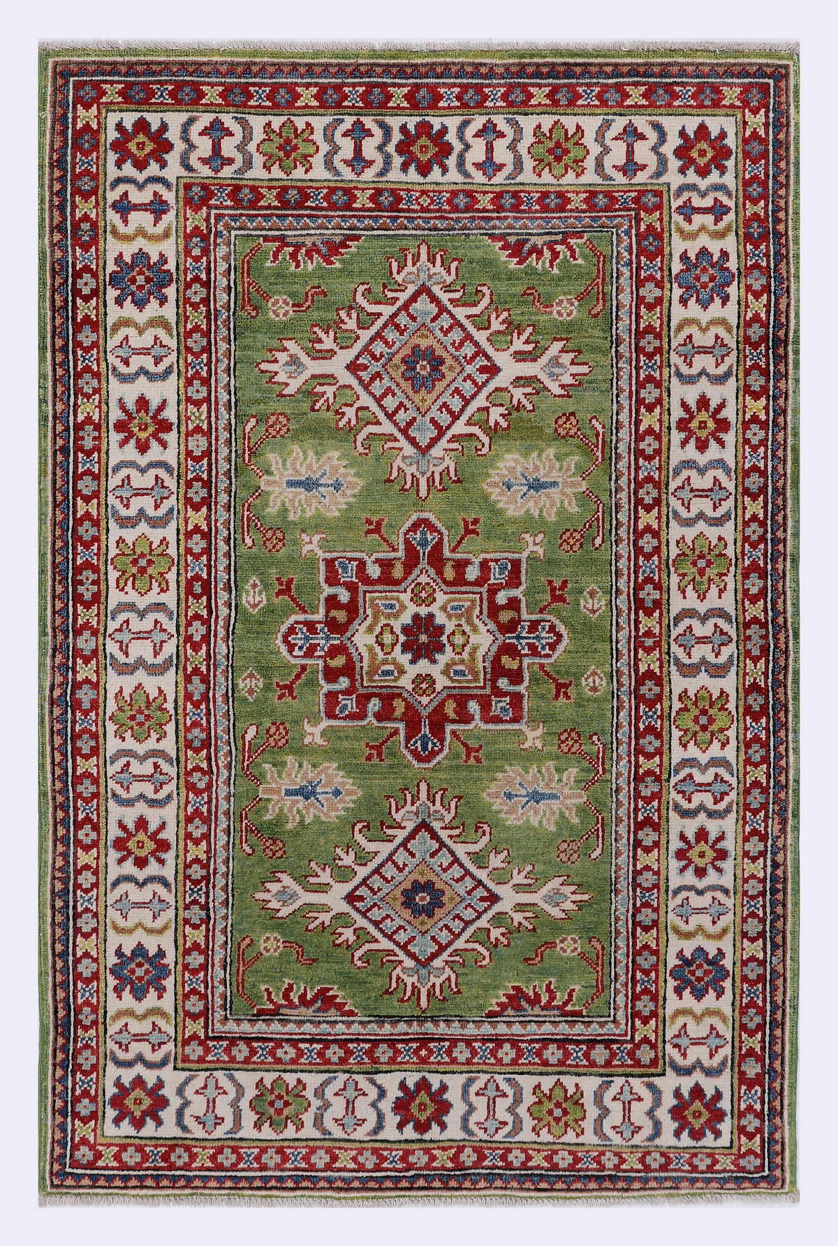 Green area rug with ornate central medallion and red-blue patterned border