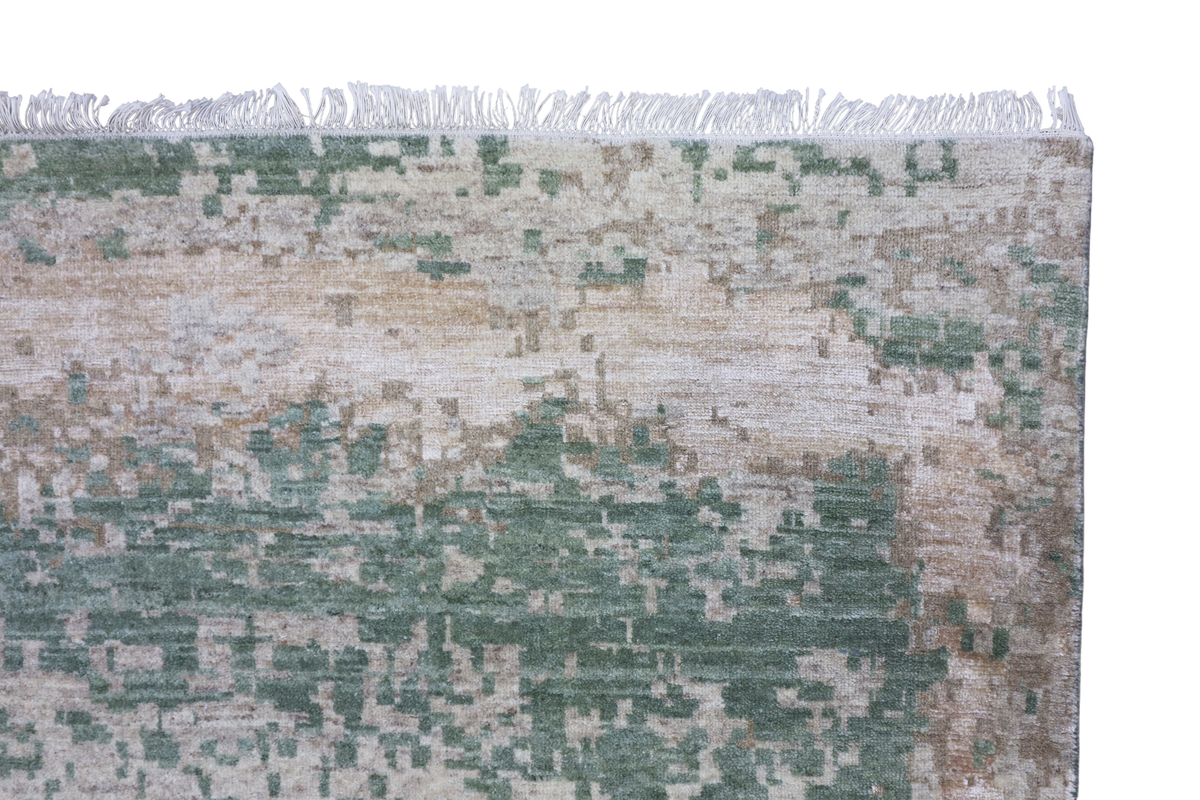 Close-up of modern abstract rug texture with jade green and beige distressed pattern