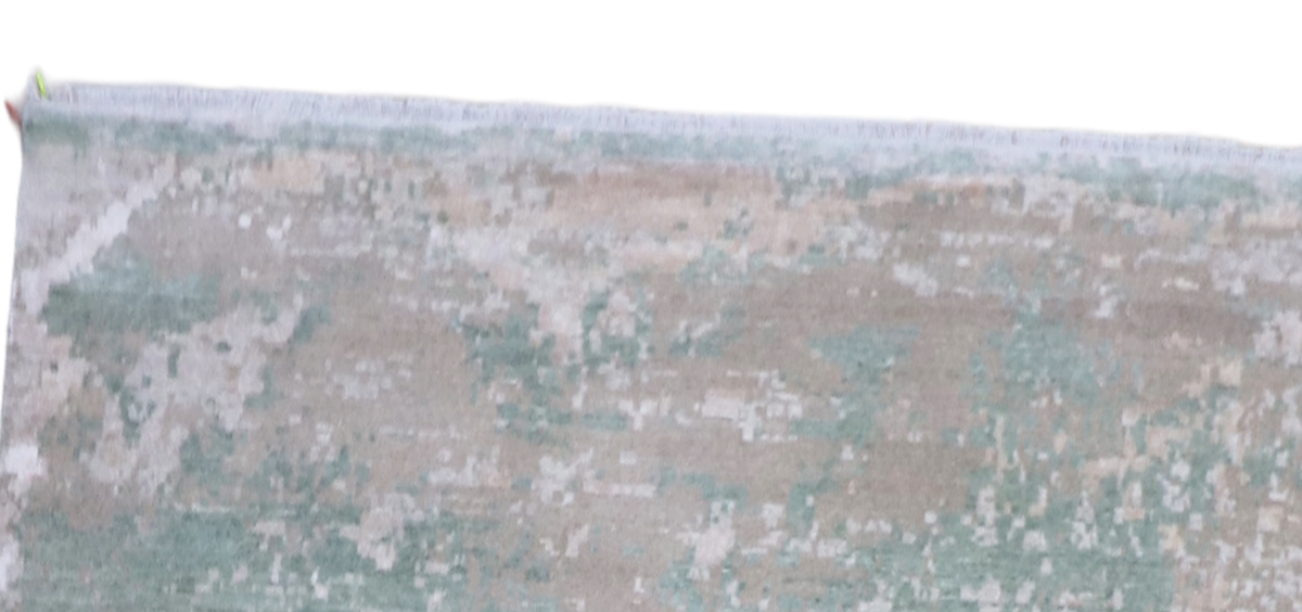 Close-up of rug top edge showing distressed texture and short fringe border