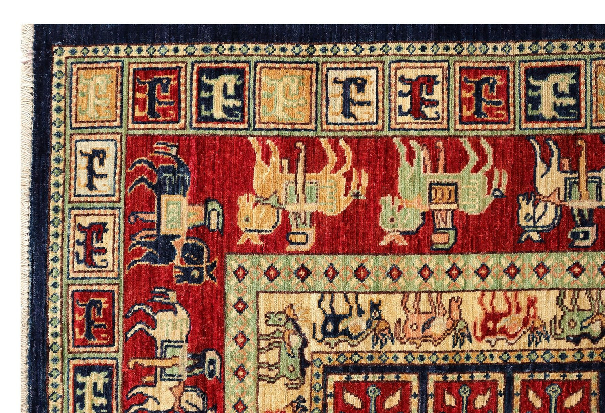 Close-up of rug pattern with red panels and blue geometric motifs along border