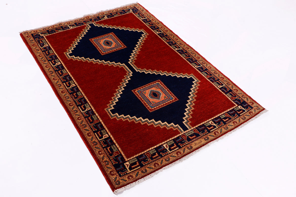 Red area rug with diamond medallions and dark blue center accents