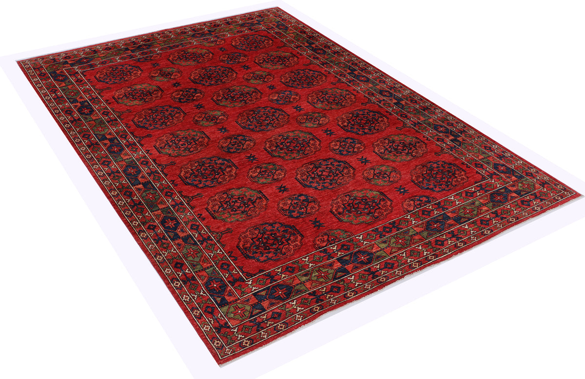 Red rug with repeating medallion pattern and dark blue border