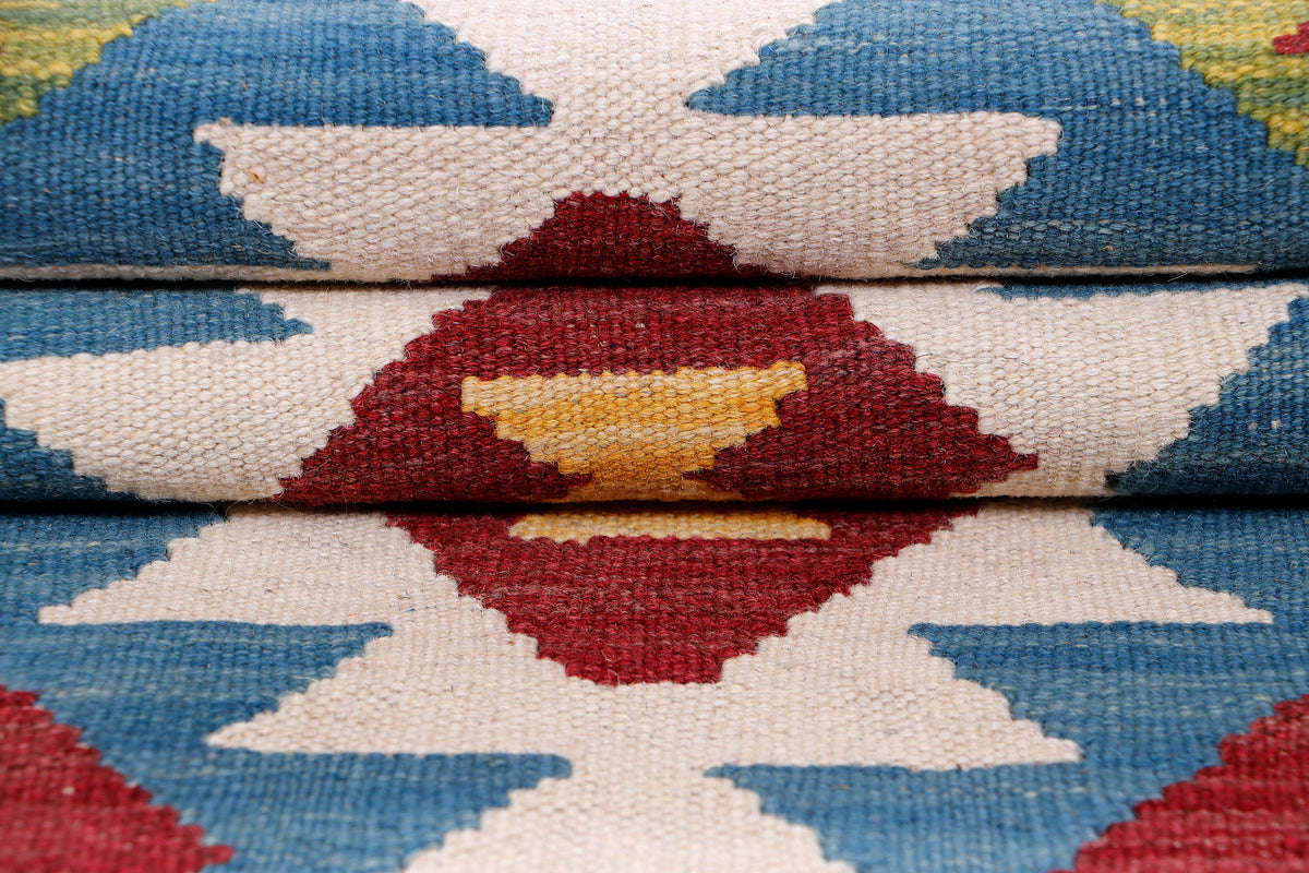 Kilim runner rug pattern detail with blue and white chevrons and red diamond accents