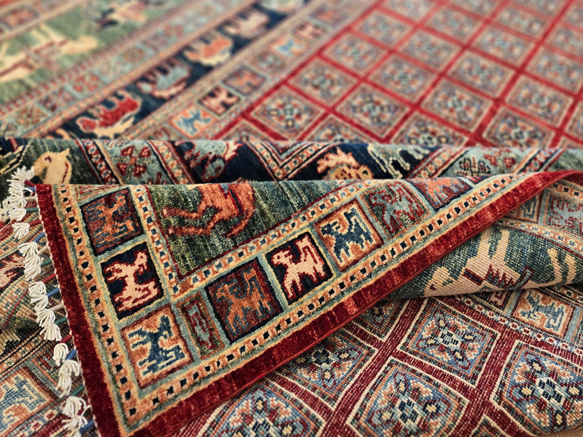 Multicolor rug edge with red fringe and geometric border bands.
