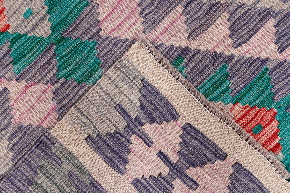 Kilim rug corner with patterned border and multicolor motif on grey and cream ground