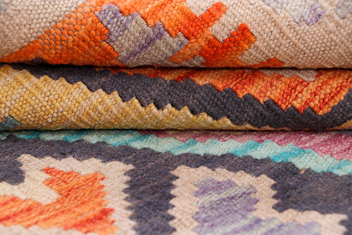 Close-up orange and cream kilim rug with zigzag and geometric motifs