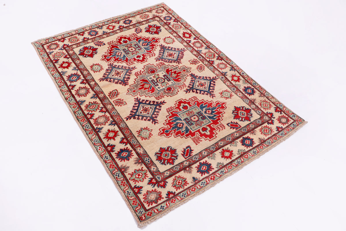 Kazak red rug with intricate geometric medallion pattern, framed by ornate border