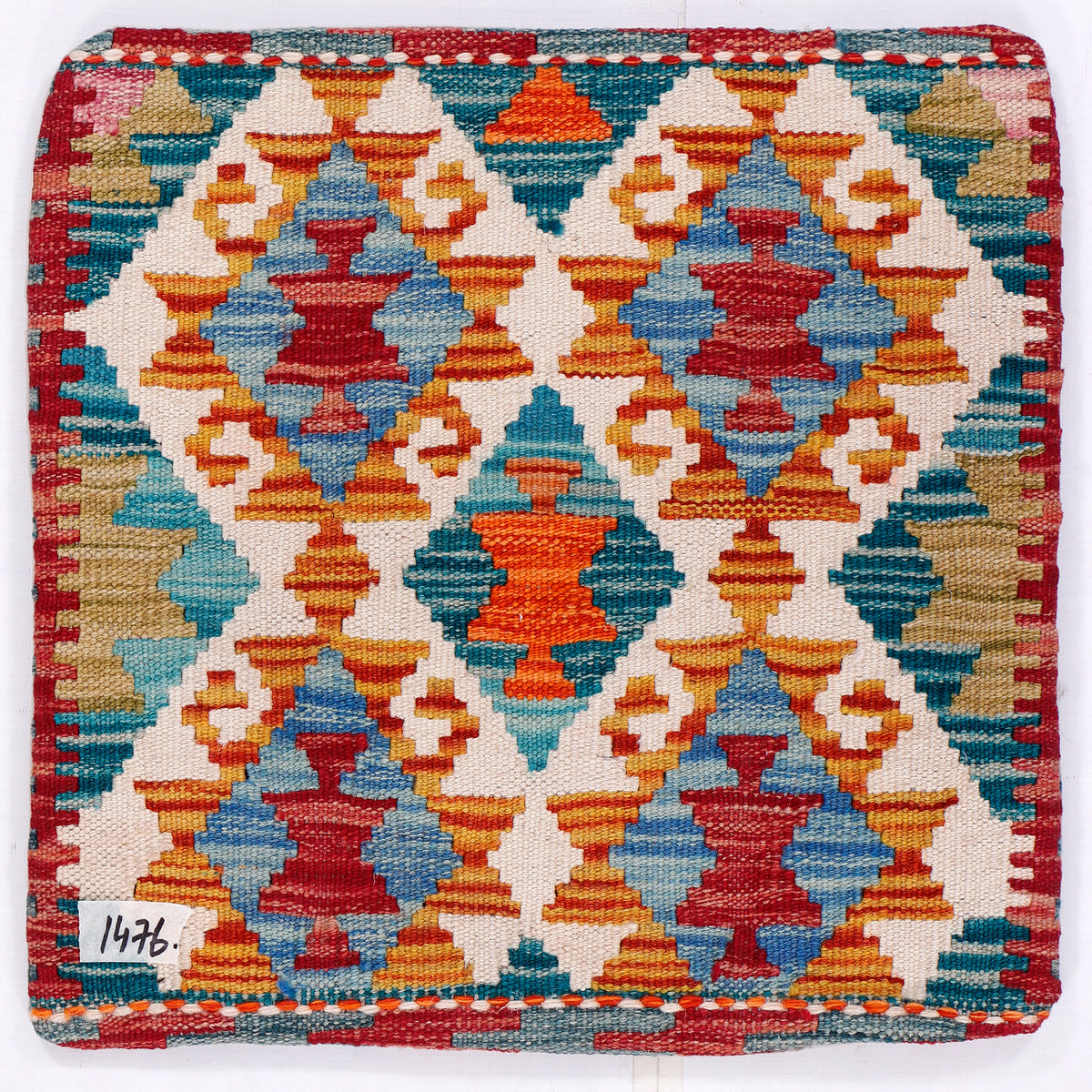 Kilim cushion cover front with multicolor diamond motif in blue, orange, red on cream.