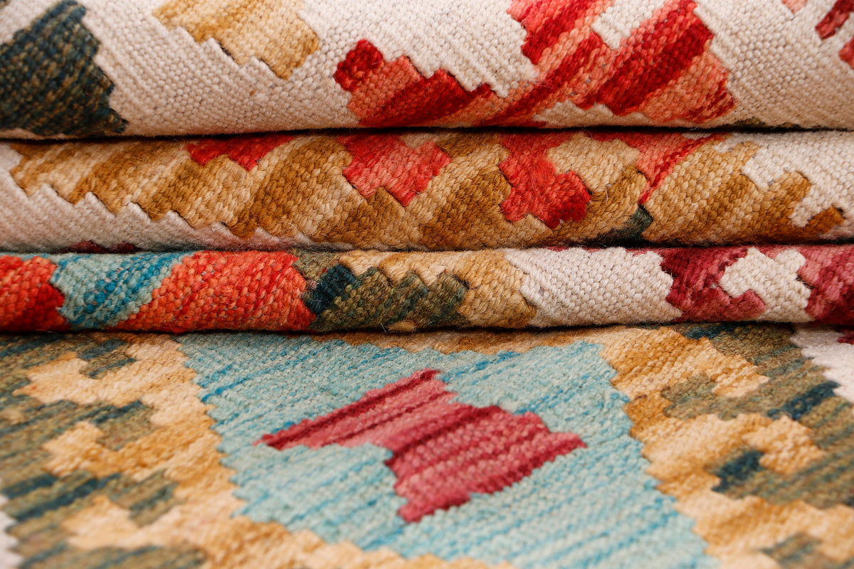 Kilim rug close-up with red, blue, and cream geometric block pattern