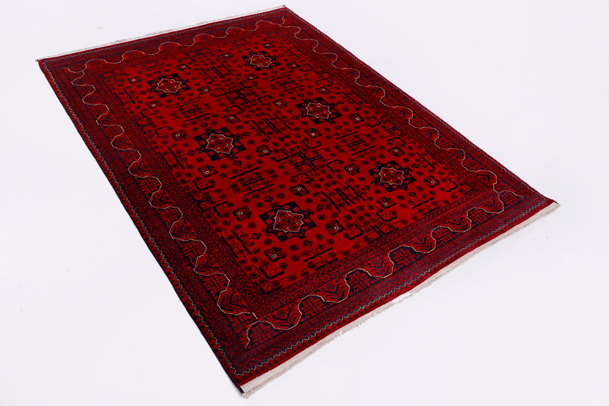 Red rectangular rug with dark medallions and intricate ornate border, flatlay
